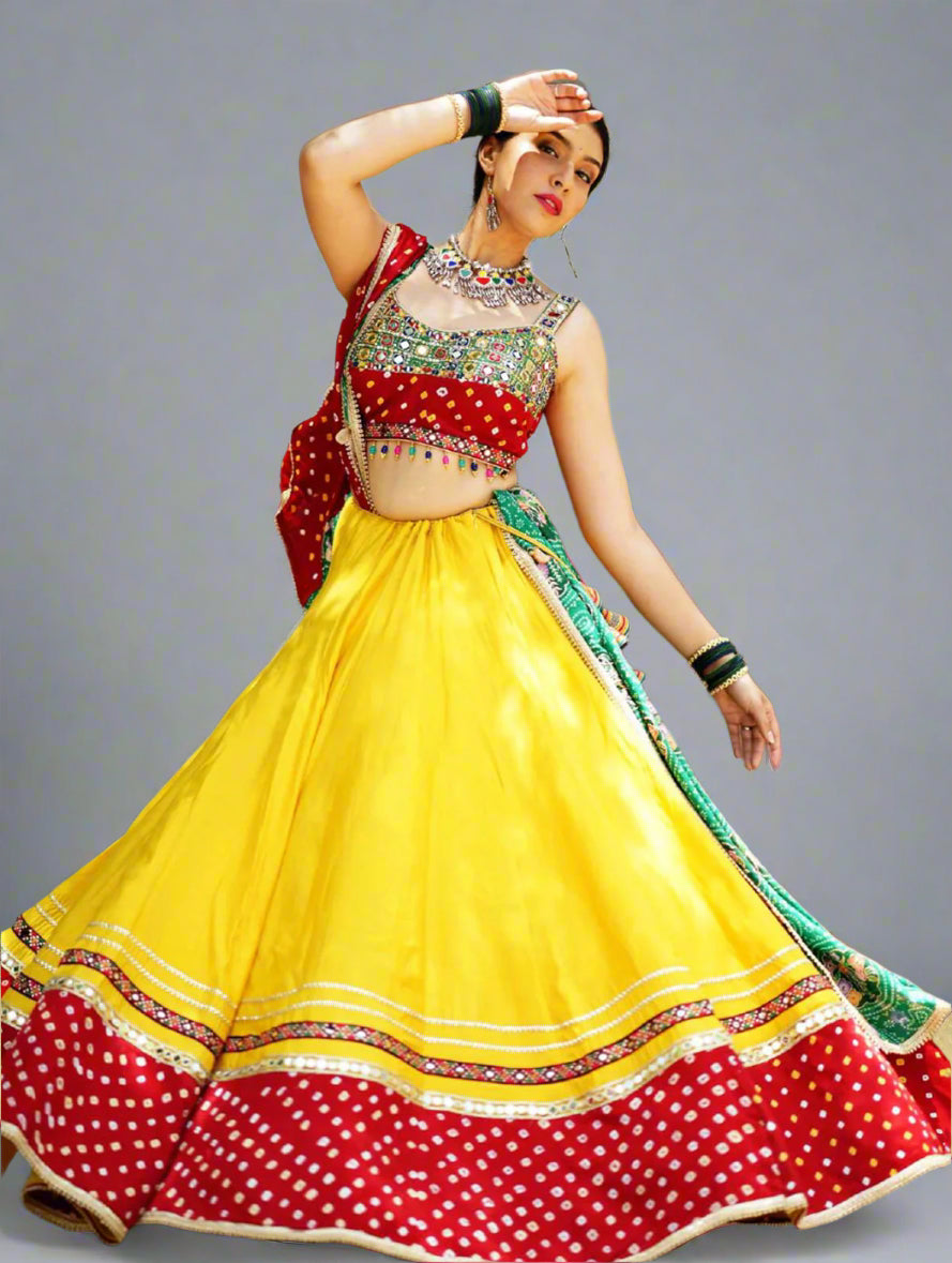Woman in a colorful traditional outfit with a yellow and red dress in an outdoor setting.